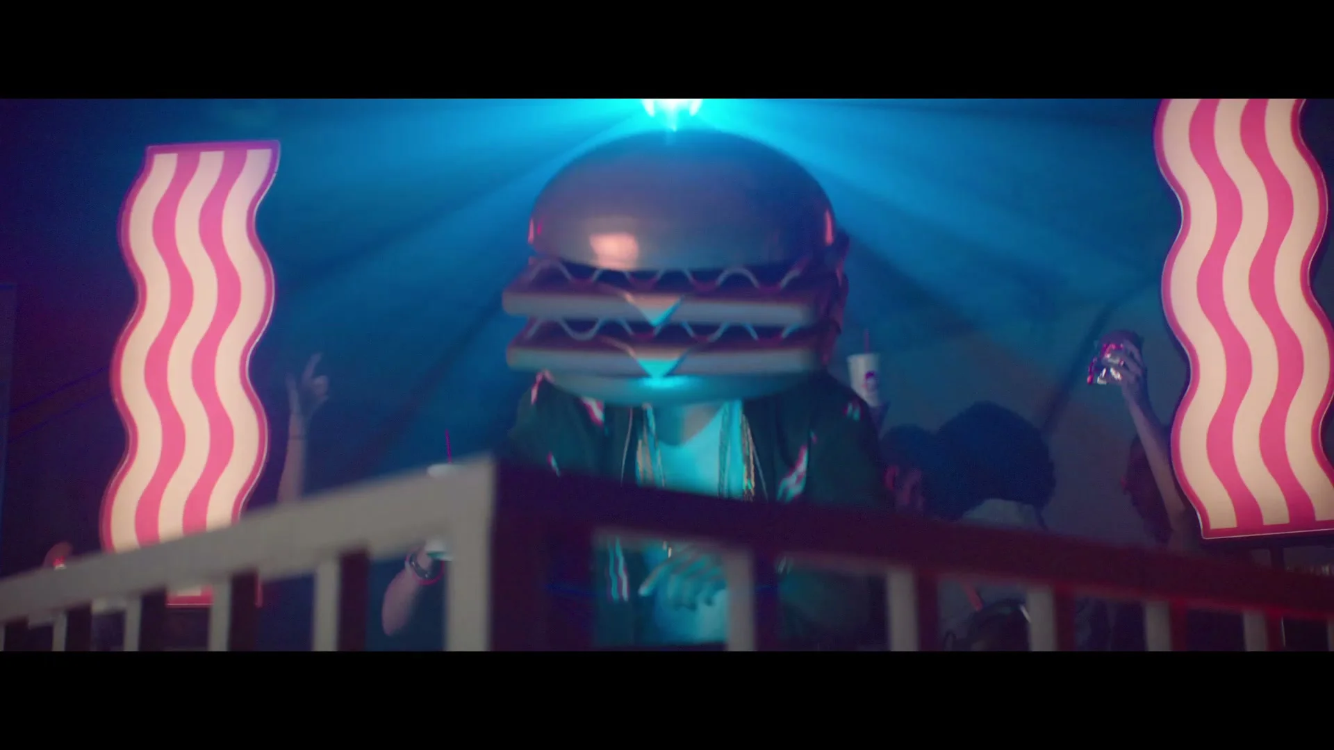 Burger-headed performer in a neon-lit Wendy’s campaign